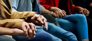 People Sitting Holding Hands
