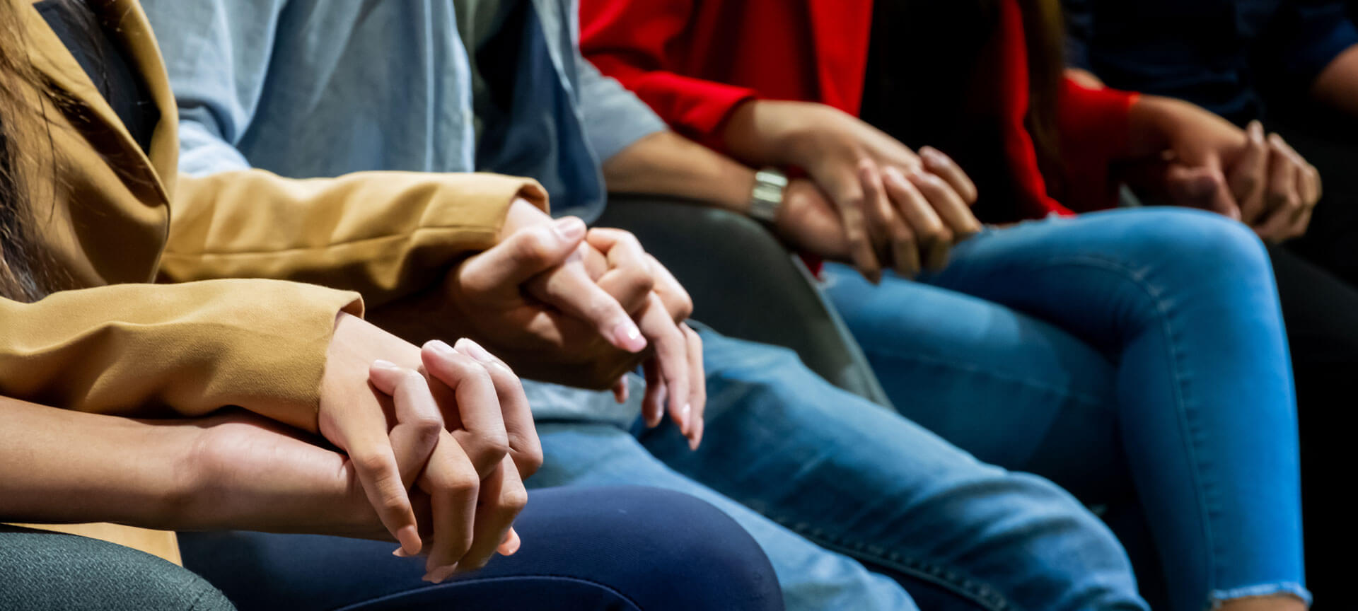 People Sitting Holding Hands